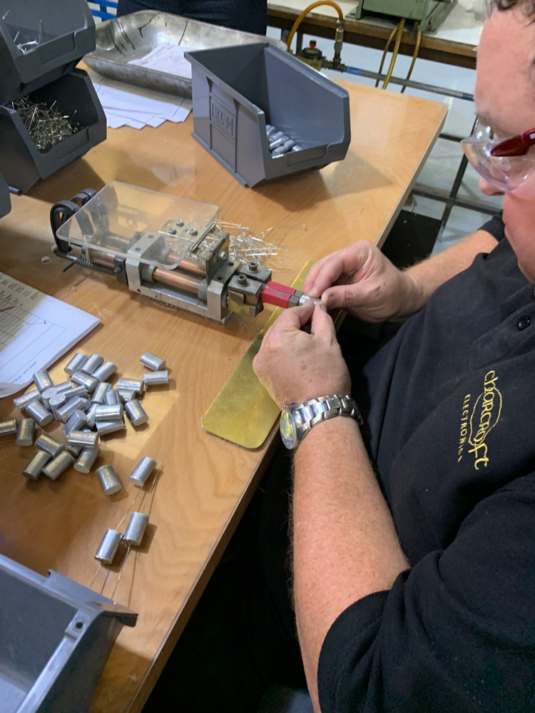 Neil applying spot welding big tail leadouts as used in industrial type capacitors.